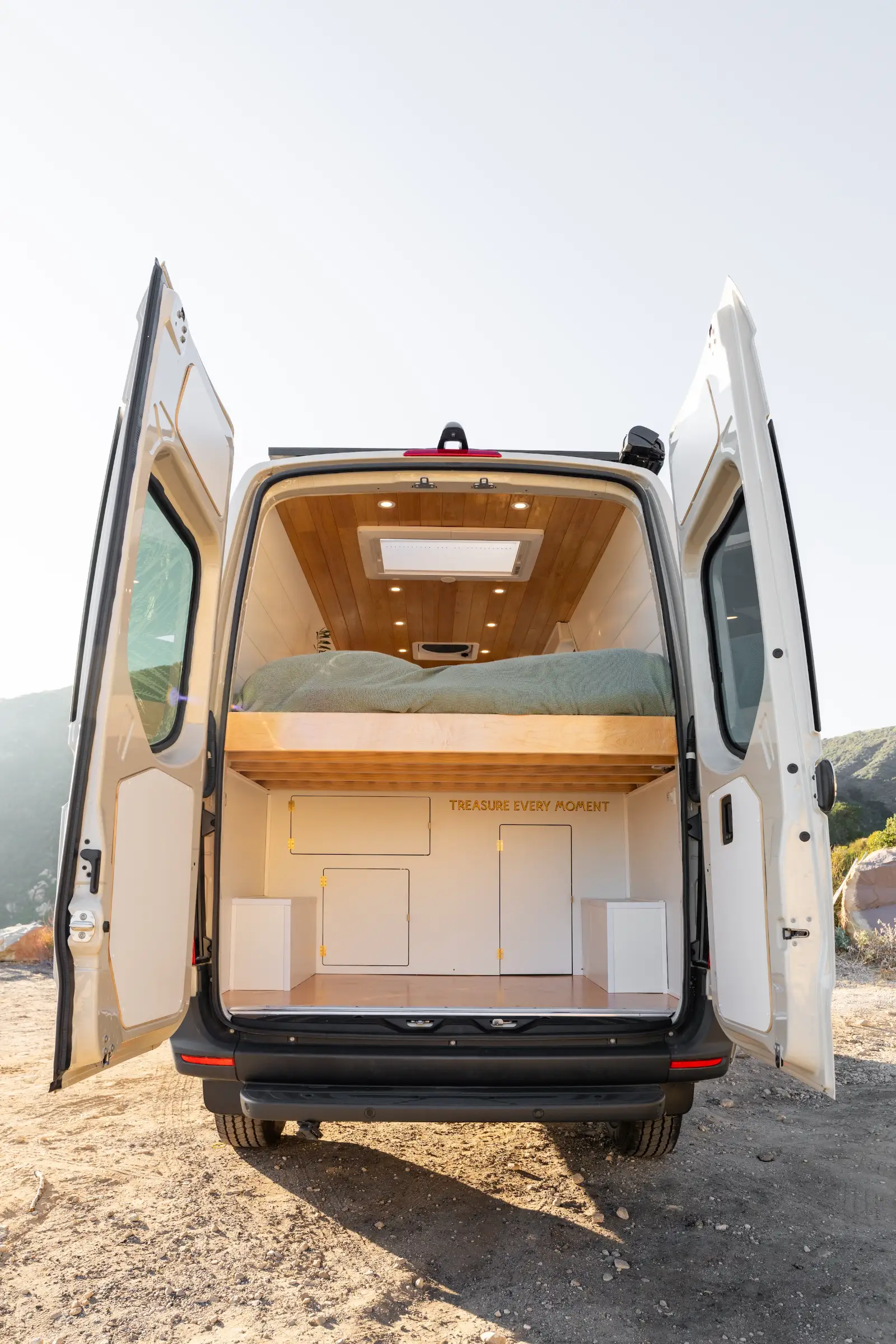 Rear doors open, bed above the garage