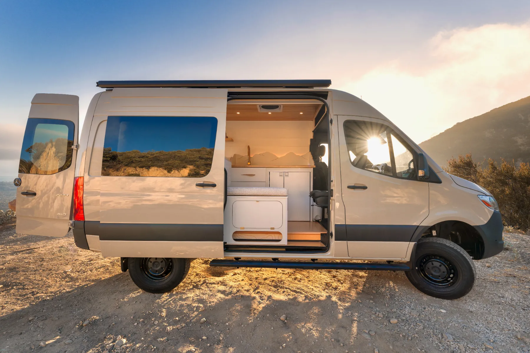 The van on a mountain overlook at sunset, side door open